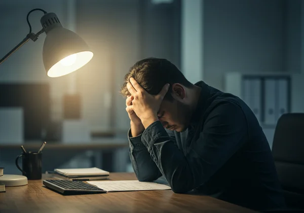 Person feeling drained and overwhelmed by work stress